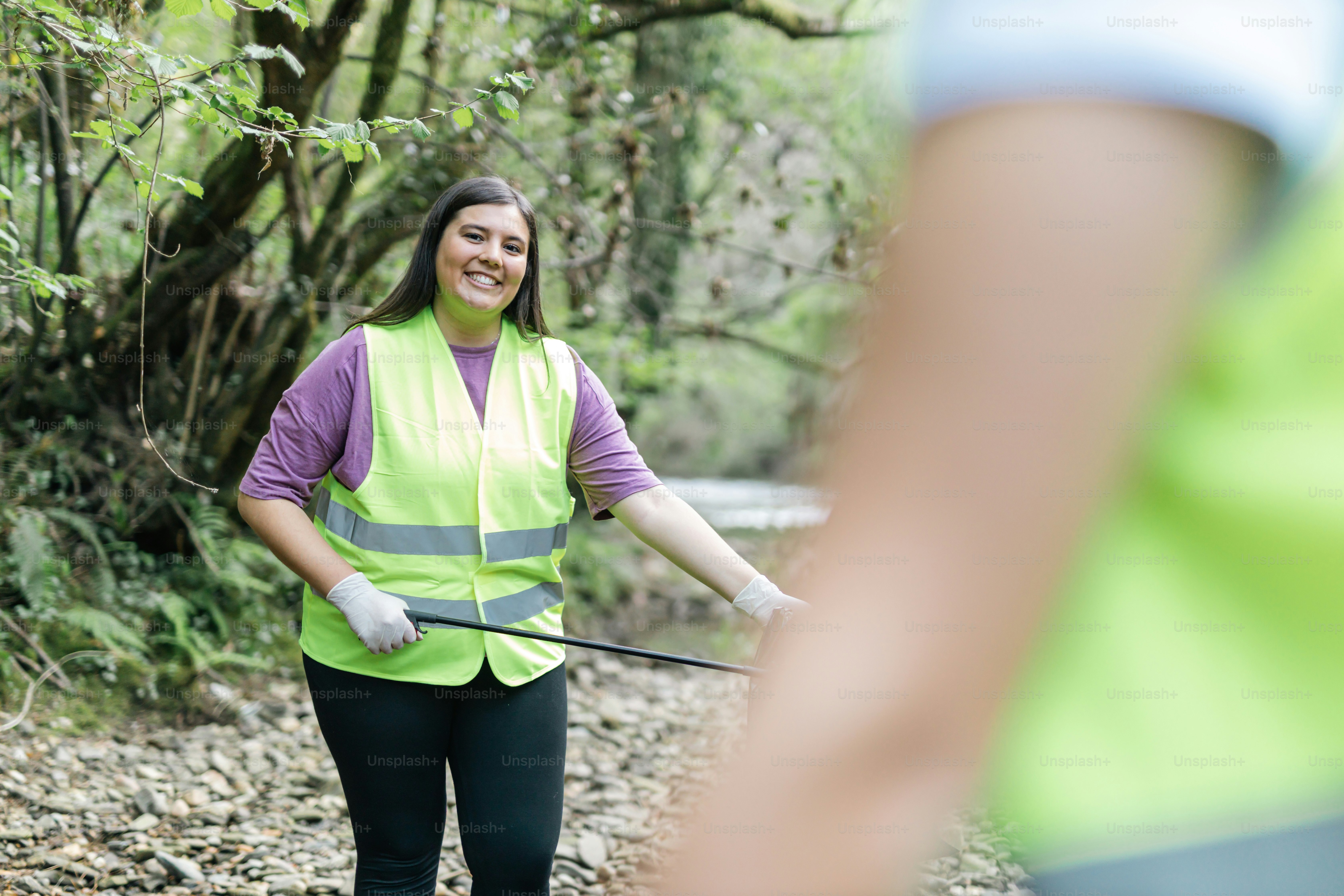 a woman in a safety vest holding a golf club