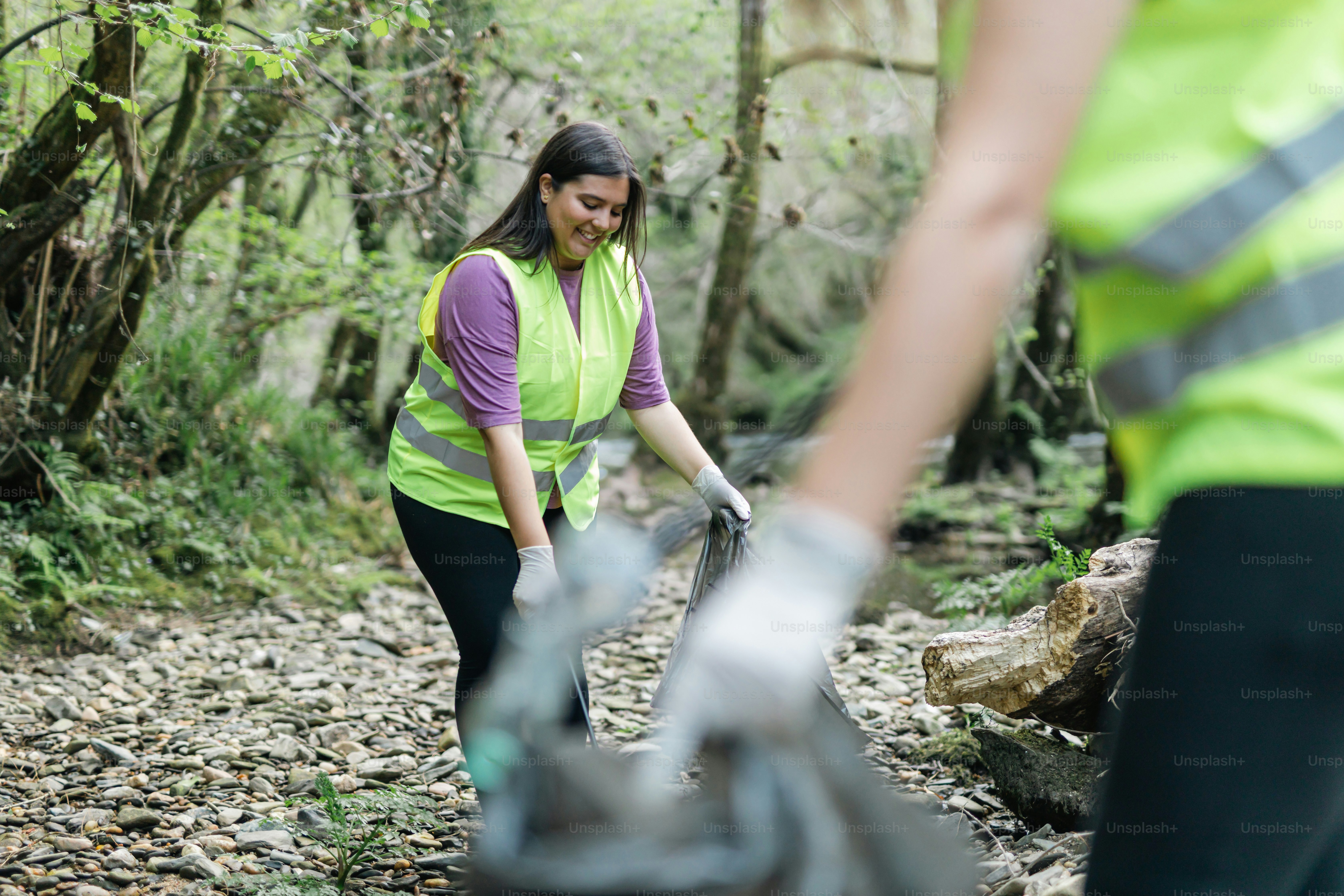 a woman in a green vest and a man in a yellow vest