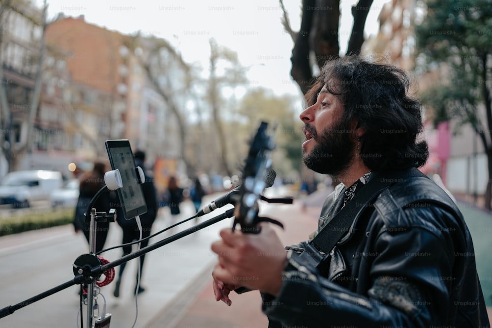 a man with long hair and beard holding a cell phone