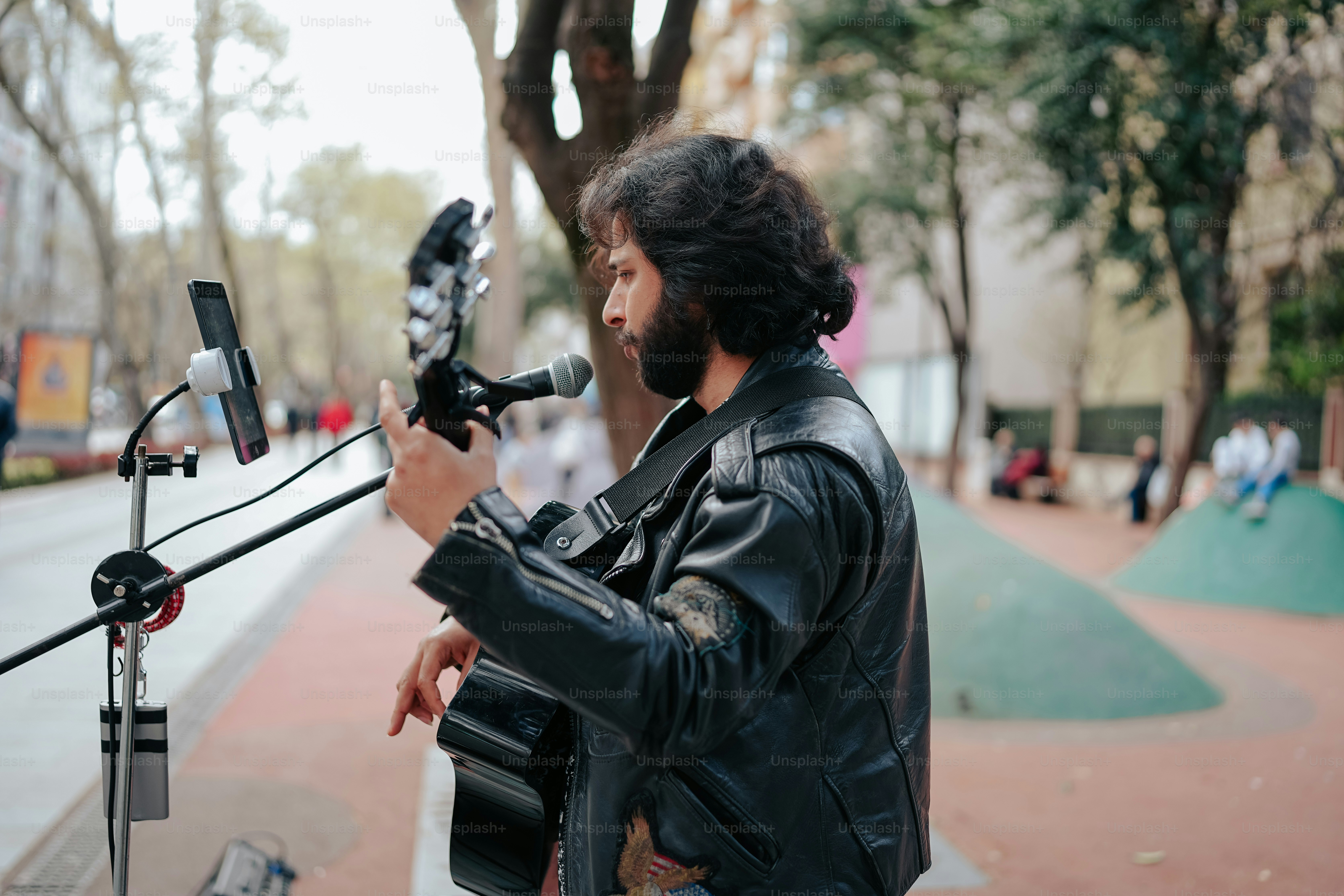 a man standing next to a microphone on a sidewalk
