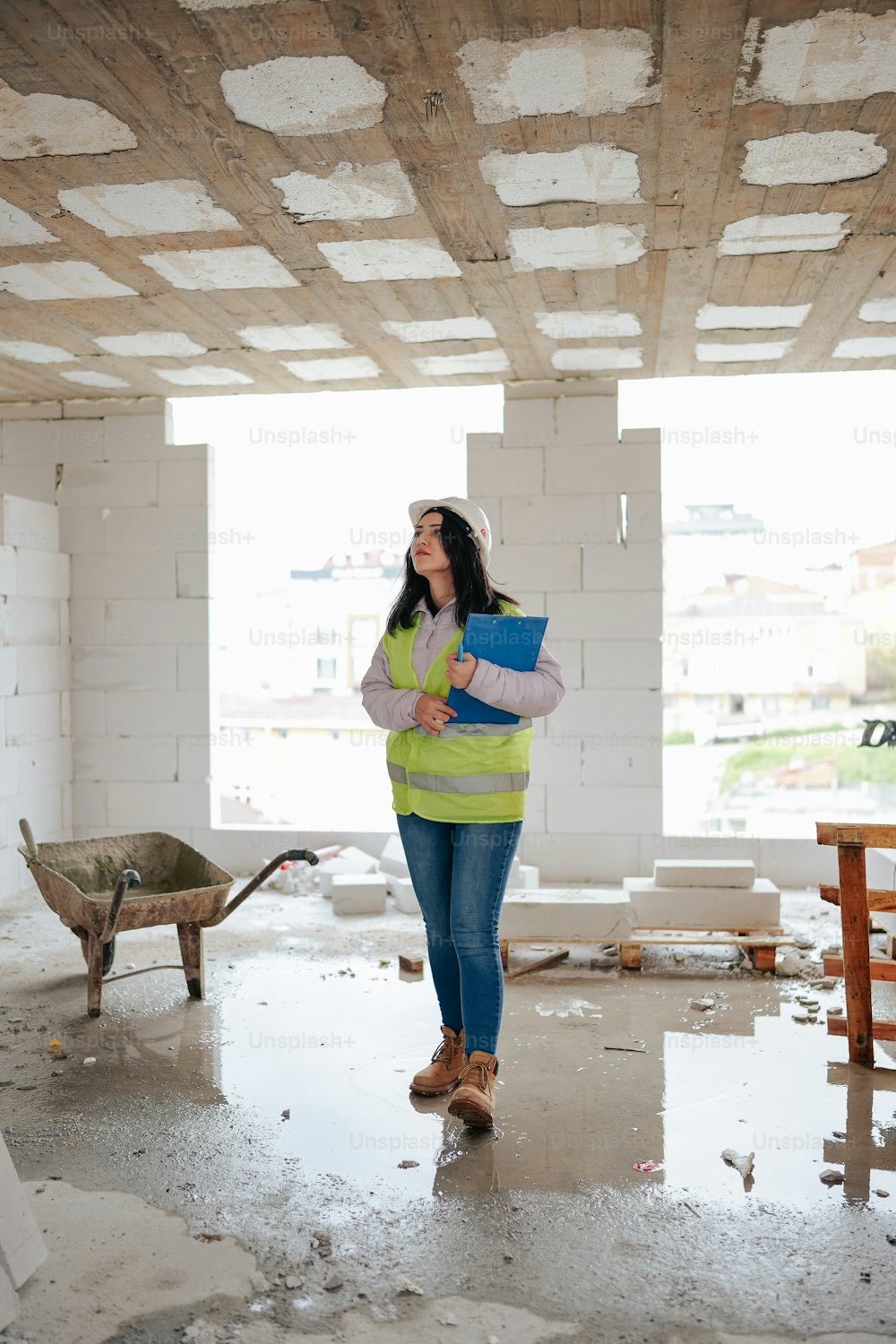 a woman standing in a room under construction