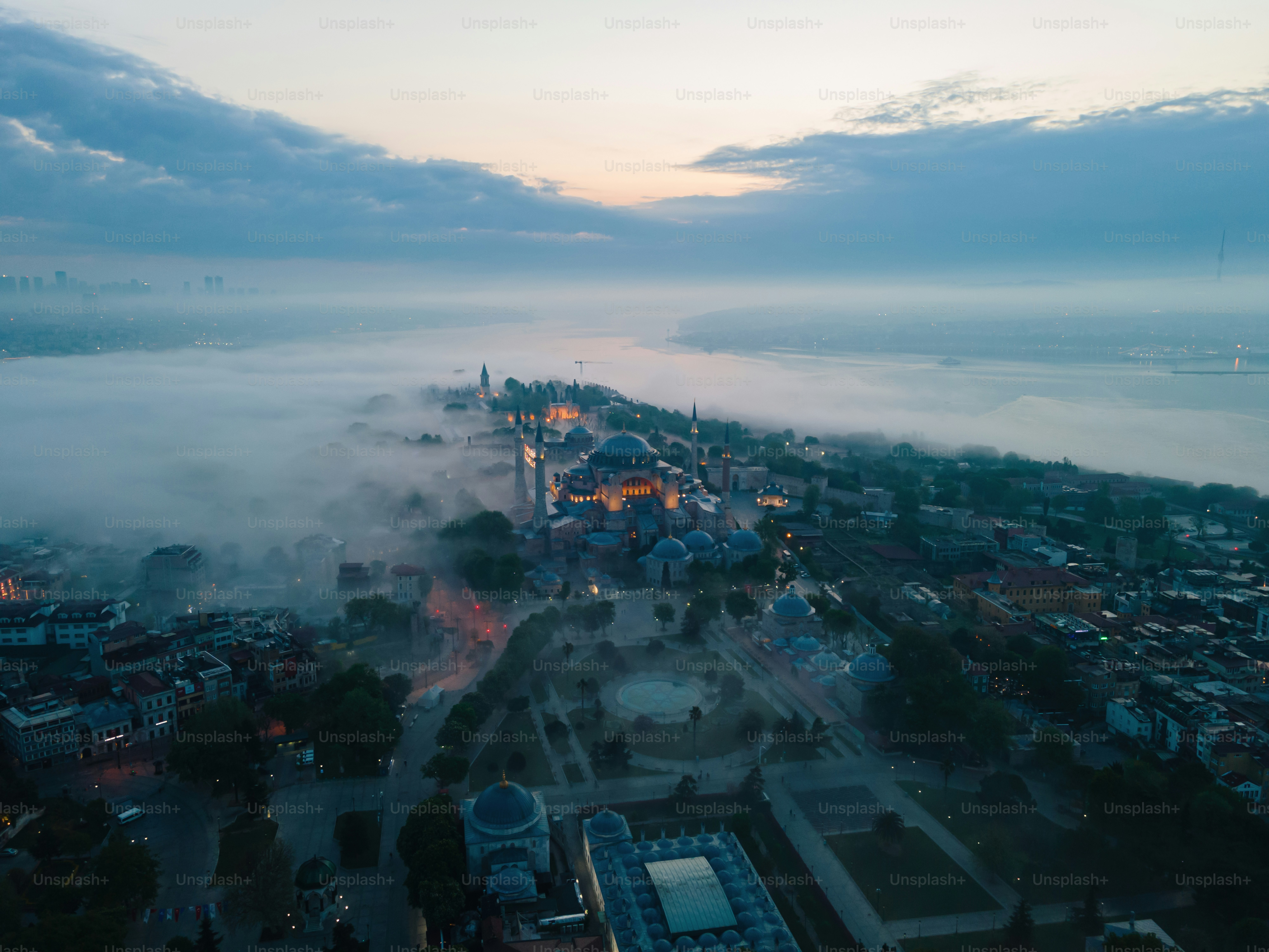 an aerial view of a city surrounded by fog