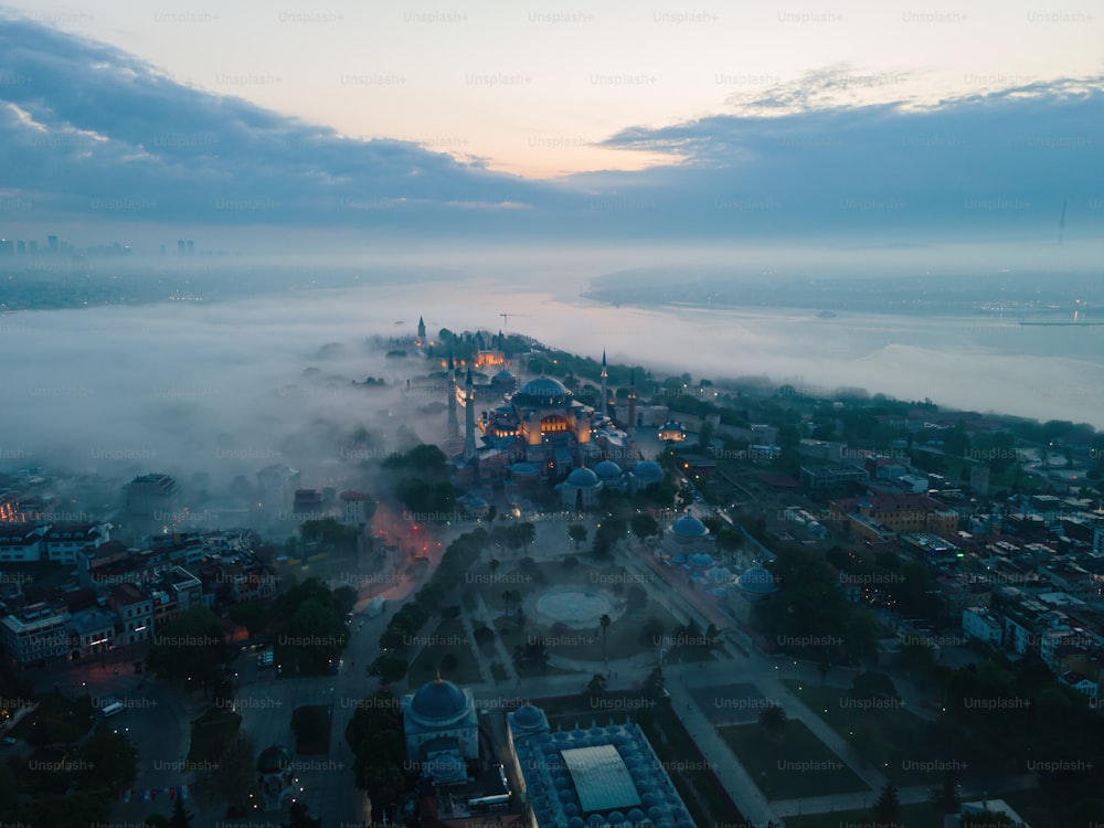 an aerial view of a city surrounded by fog