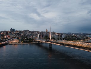a bridge over a river with a city in the background