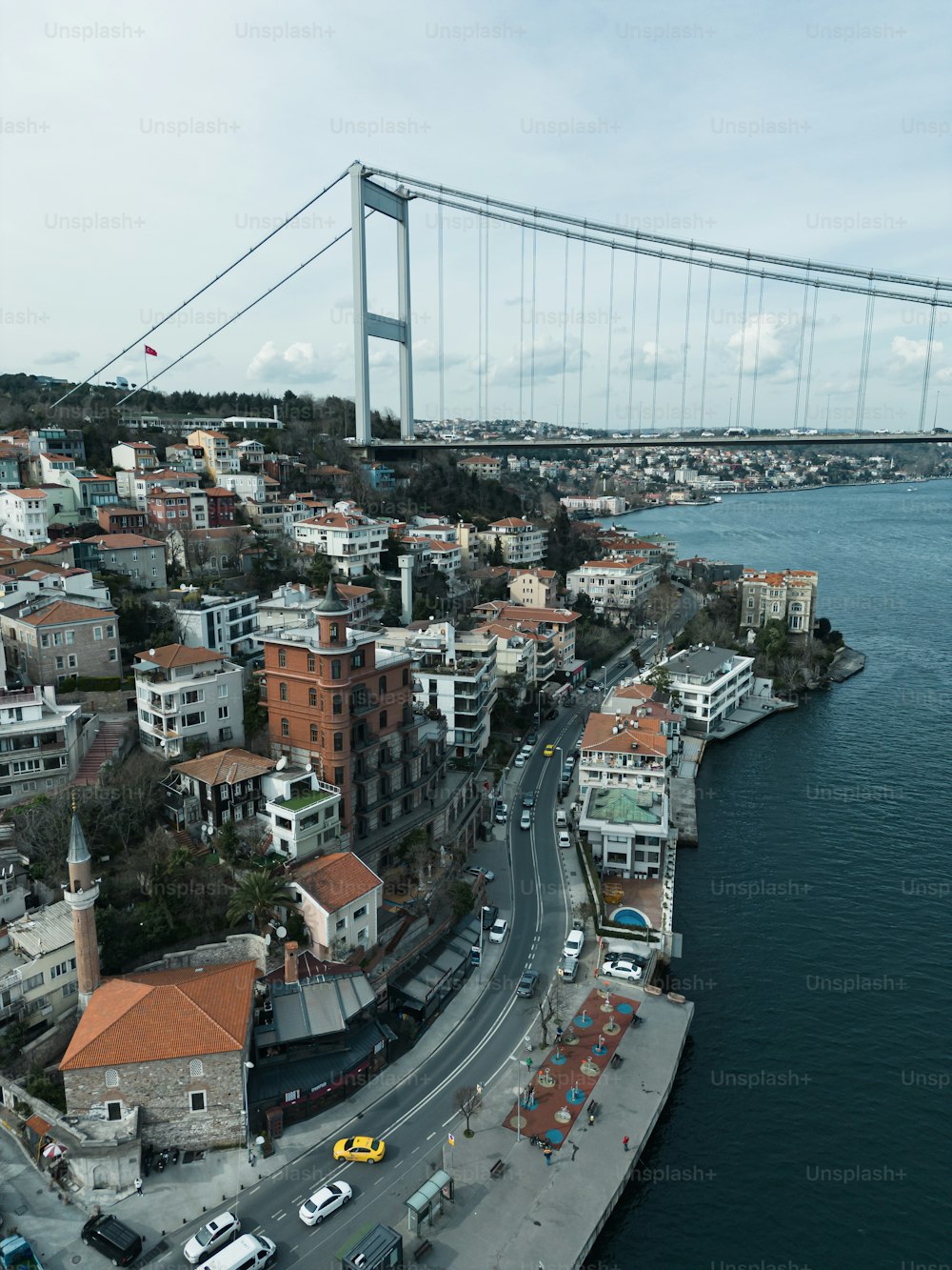 an aerial view of a city with a bridge in the background