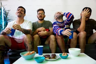 a group of men sitting on top of a couch