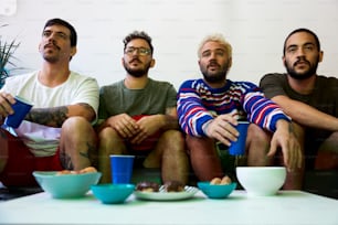 a group of men sitting on top of a couch