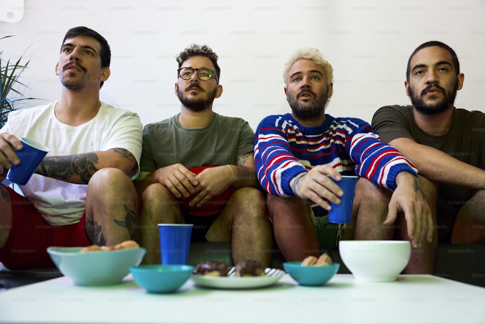 a group of men sitting on top of a couch