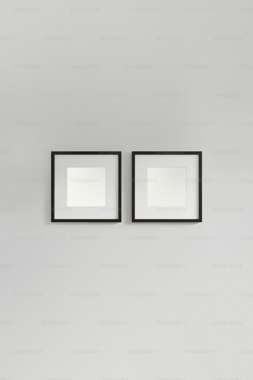 two black and white framed pictures hanging on a wall