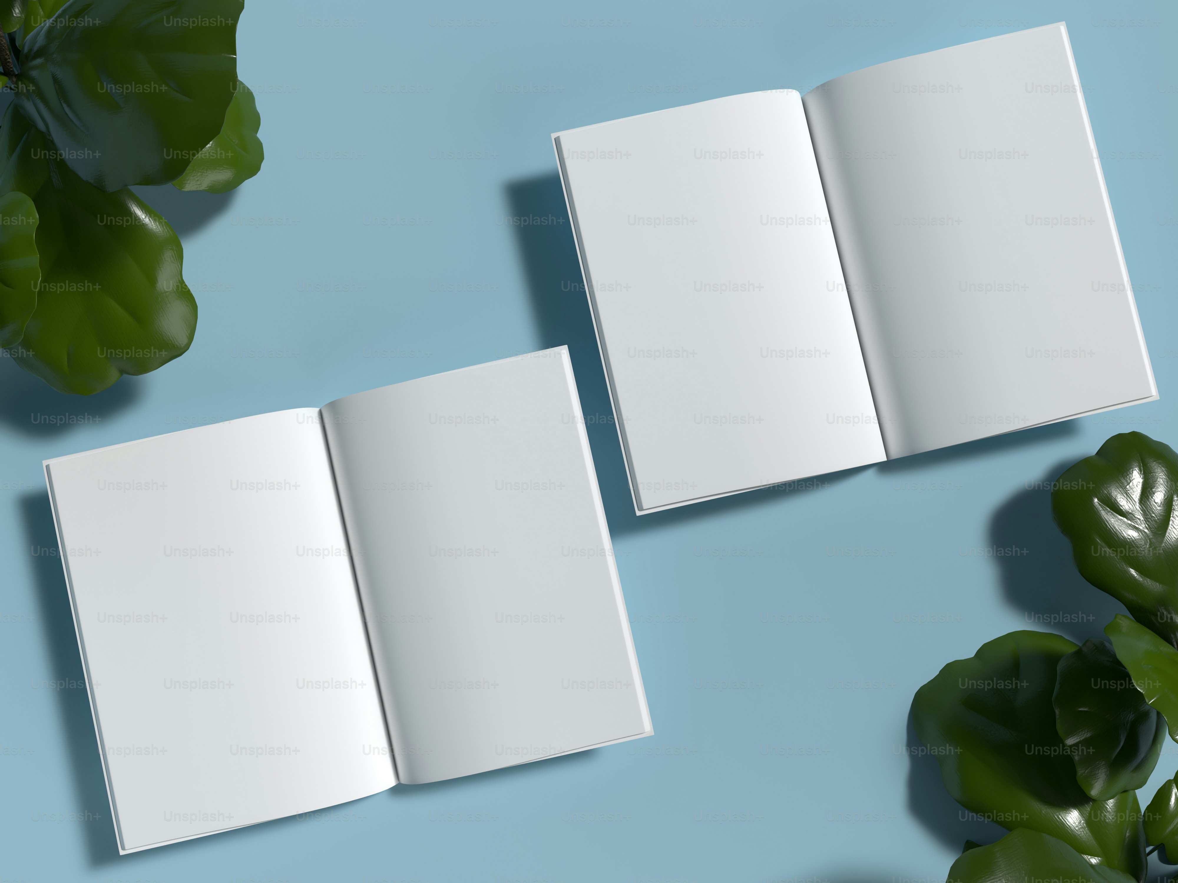 an open book sitting on top of a table next to a plant