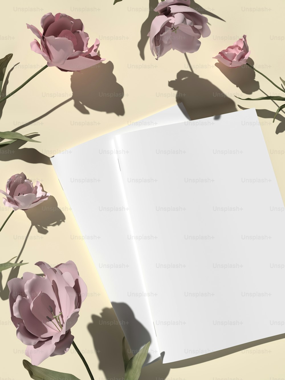 Ein offenes Buch auf einem Tisch mit rosa Blumen