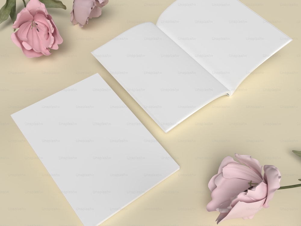 ein offenes Buch neben rosa Blumen auf einem Tisch