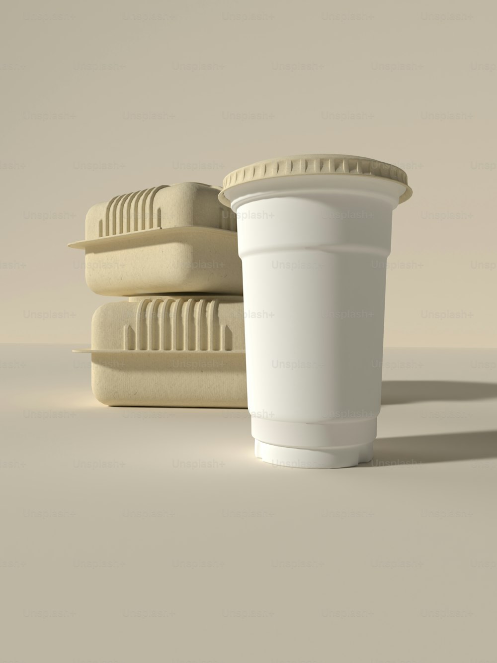 a cup of coffee sitting next to a stack of mattresses