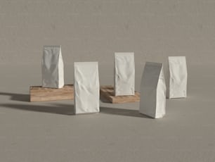 a group of white bags sitting on top of a wooden stand