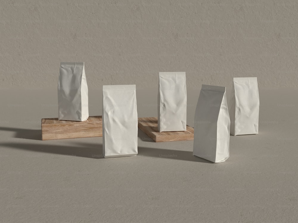 a group of white bags sitting on top of a wooden stand