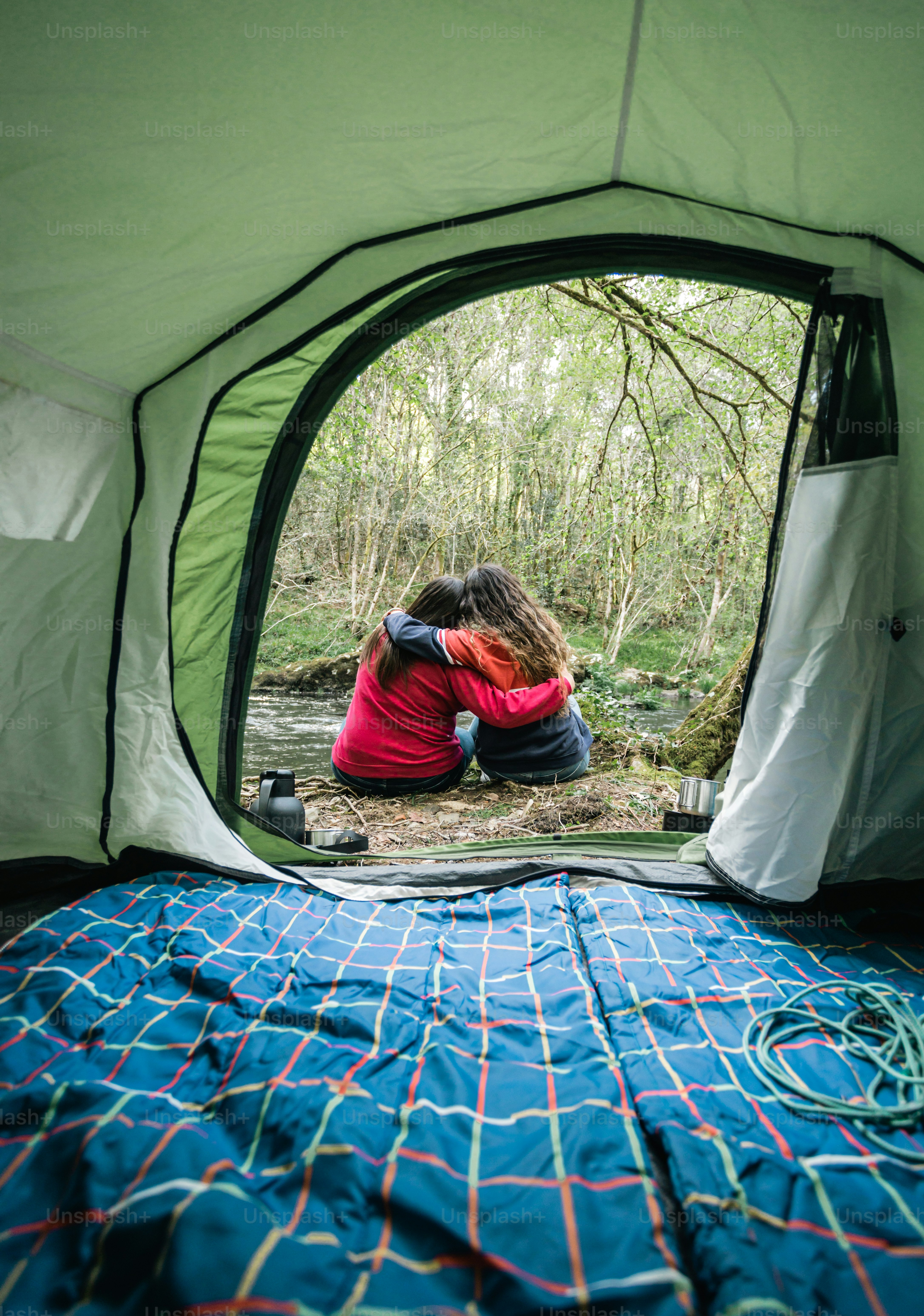 a couple of people sitting in a tent