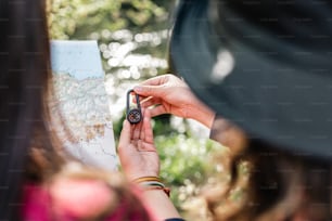 a woman looking at a map with a compass in her hand