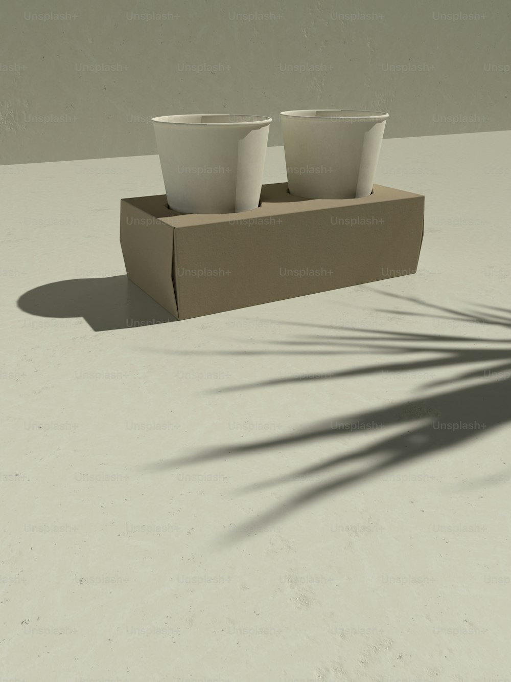 three white cups sitting on top of a cardboard box