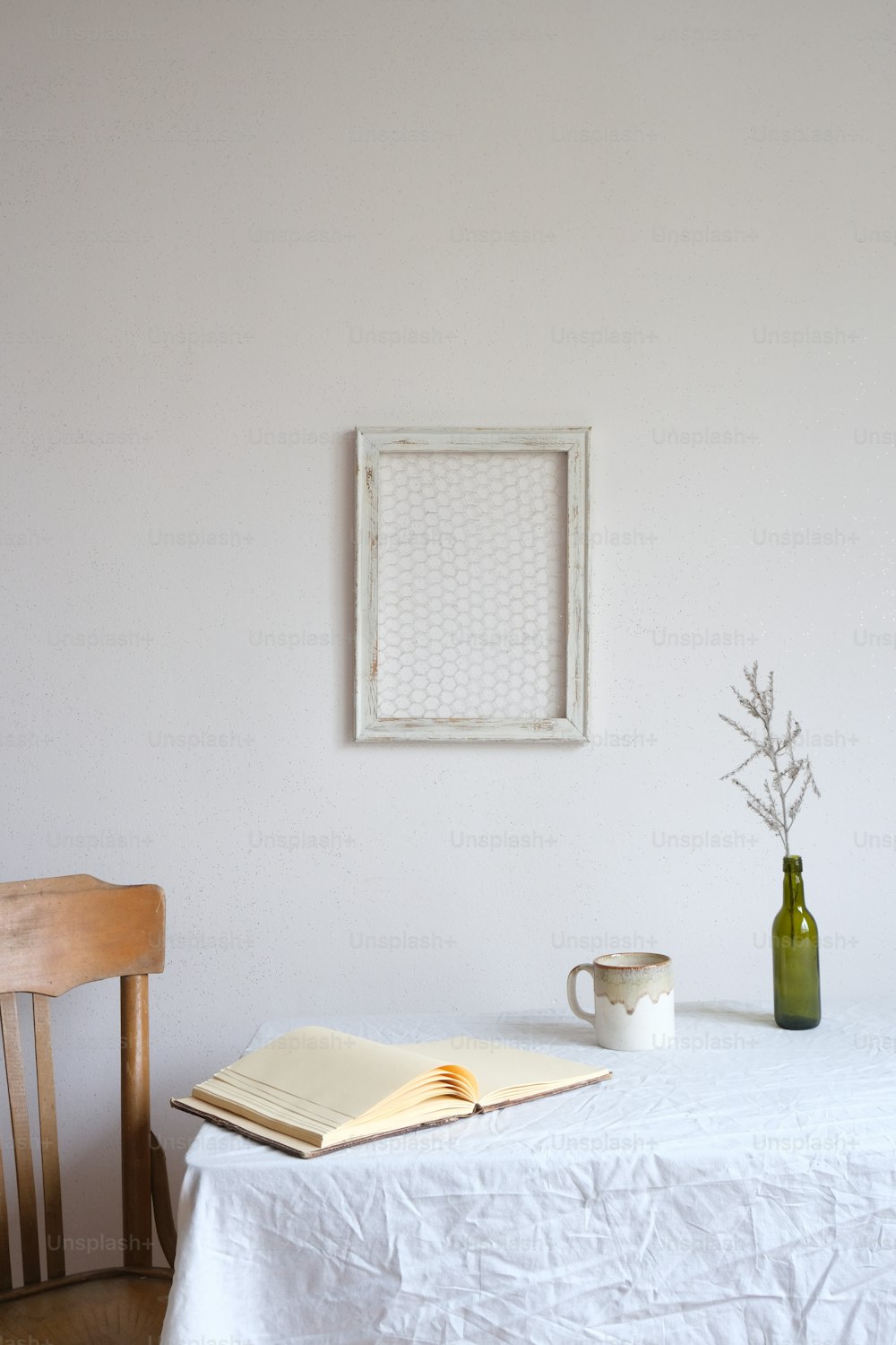 a table with a book and a vase on it