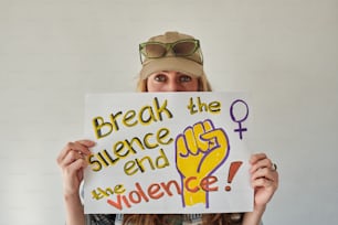 a woman holding up a sign with words on it