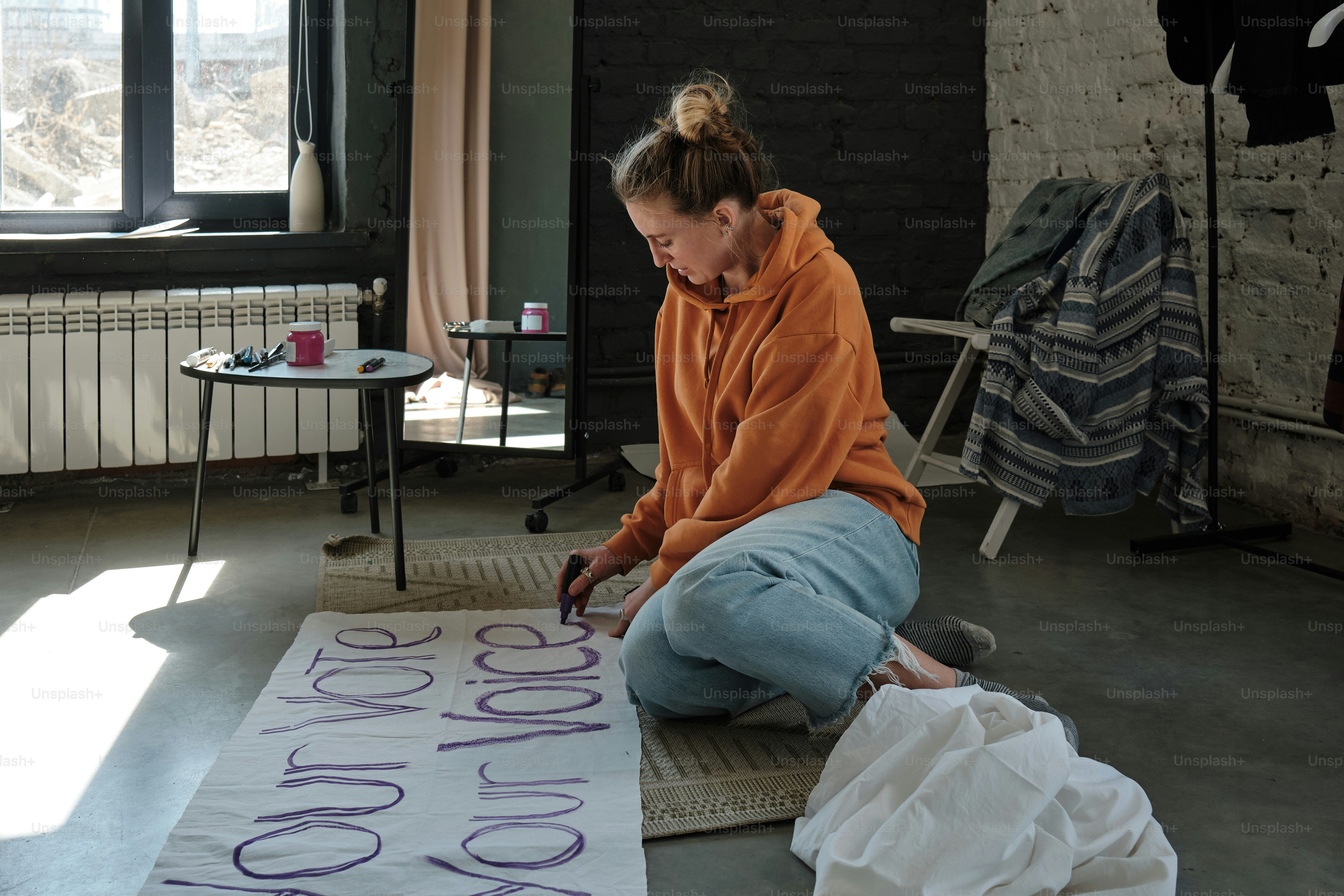 a woman sitting on the floor of a room