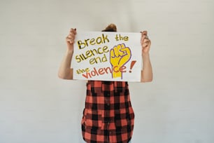 a person holding a sign that says break the science agenda