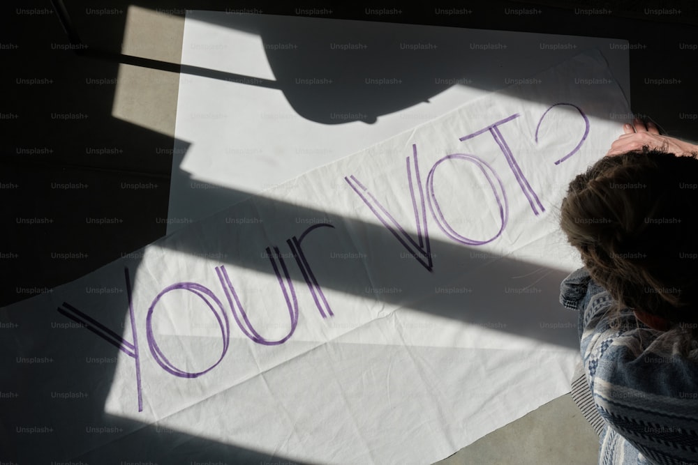 a person writing on a piece of paper