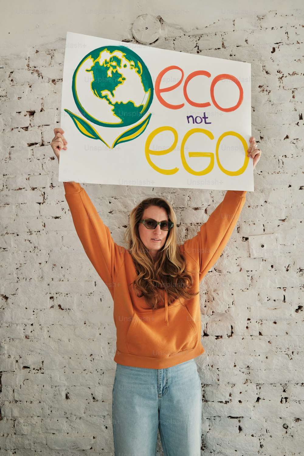 Eine Frau, die ein Schild mit der Aufschrift Eco not Eco hält
