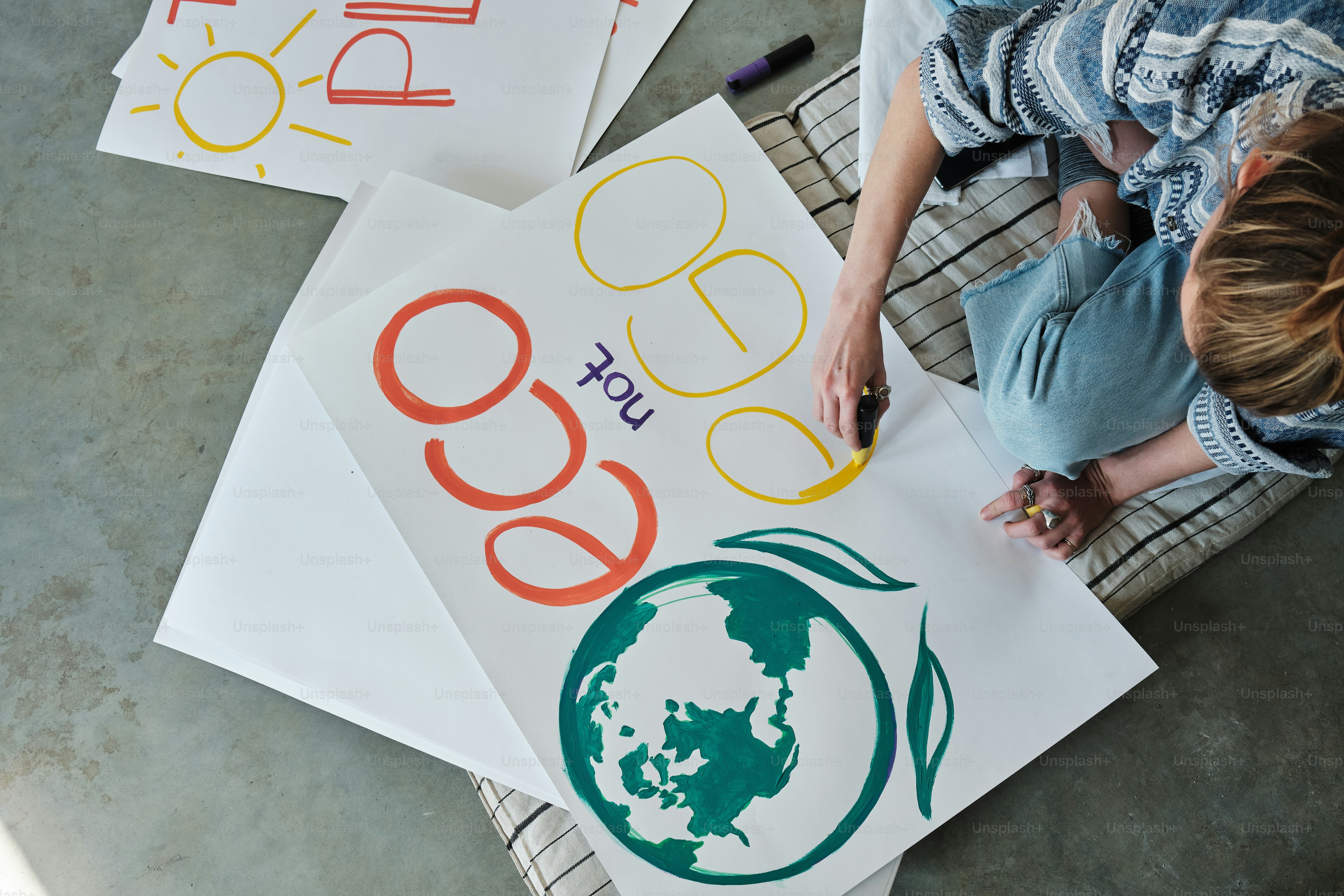 a woman sitting on a chair with three signs in front of her