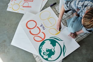 a woman sitting on a chair with three signs in front of her