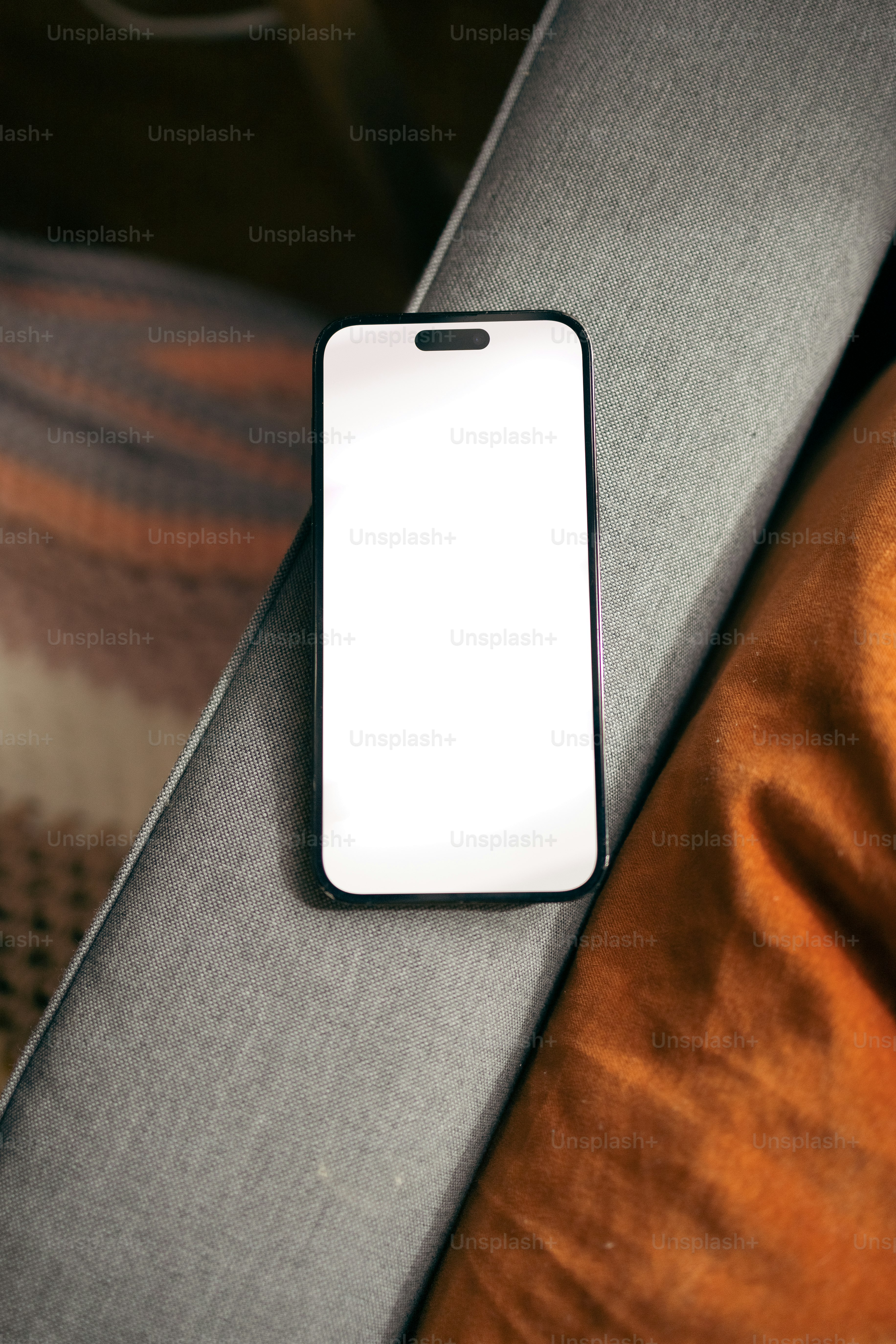 a cell phone sitting on top of a couch