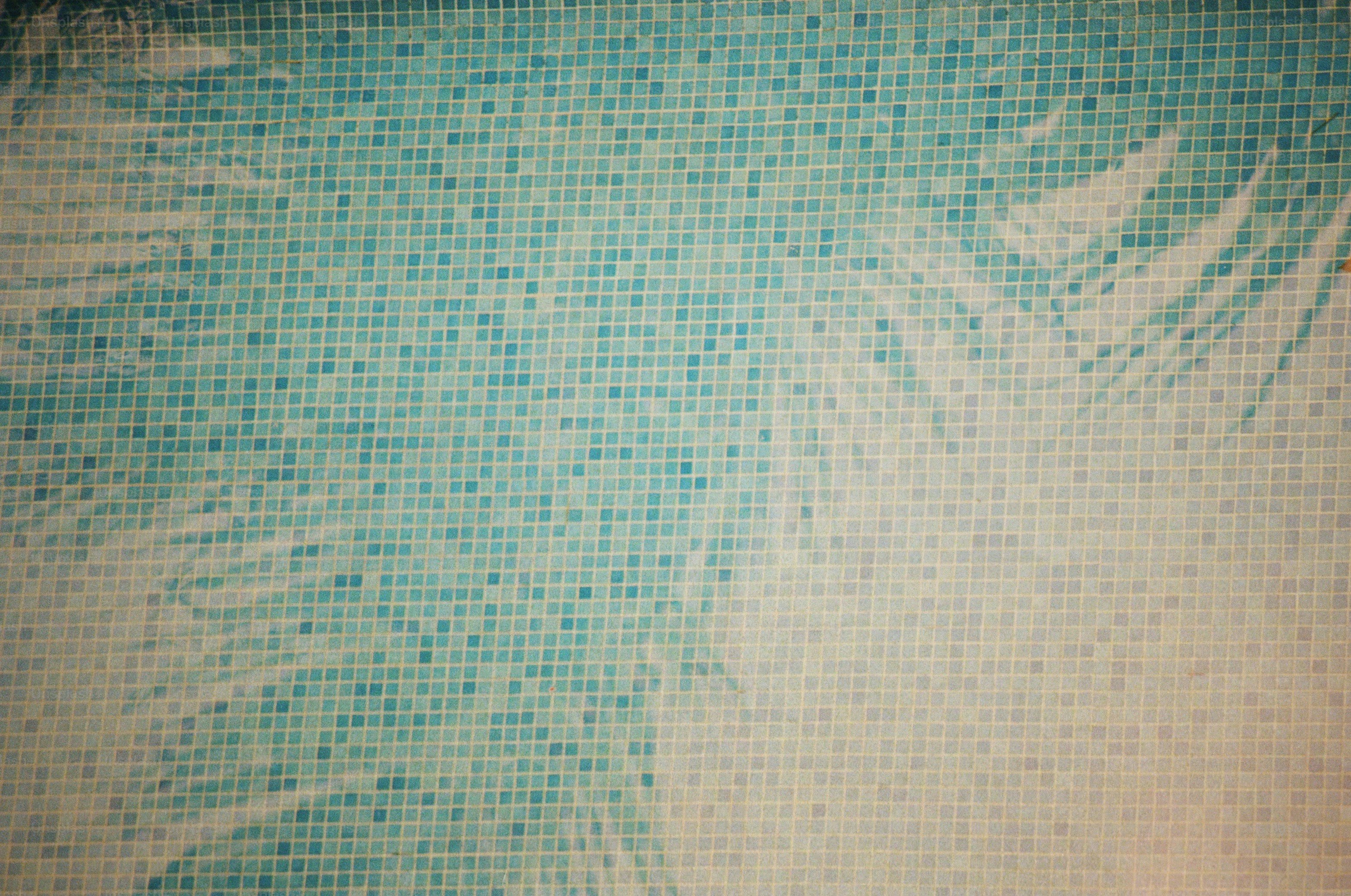 a close up of a blue and white tiled wall