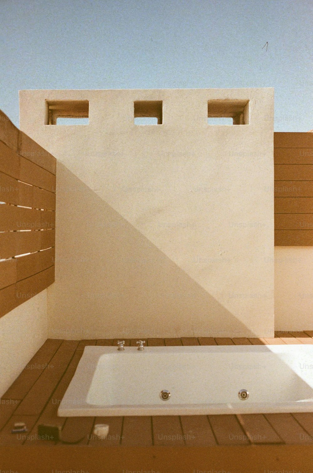 a white bath tub sitting on top of a wooden floor