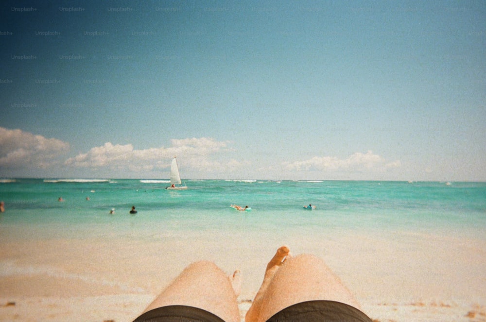 a person laying on a beach next to the ocean