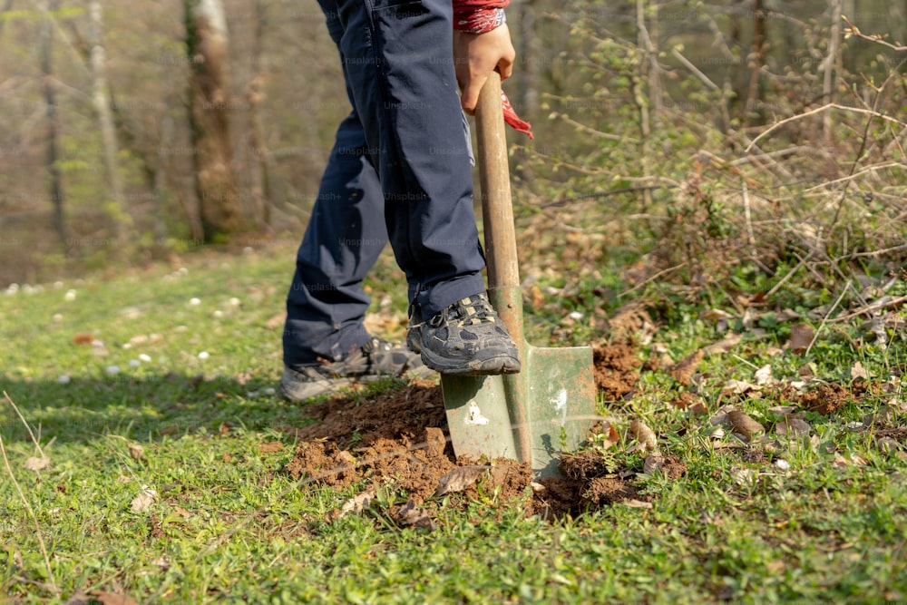 a man digging in the ground with a shovel