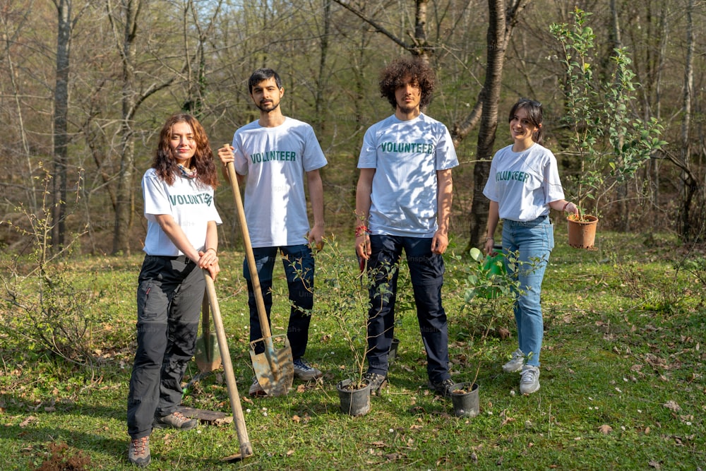 a group of people standing next to each other in a forest