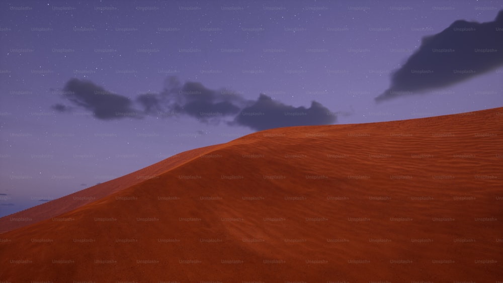 Une colline de sable avec un ciel rempli d’étoiles en arrière-plan