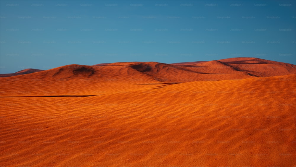 a desert landscape with a blue sky in the background