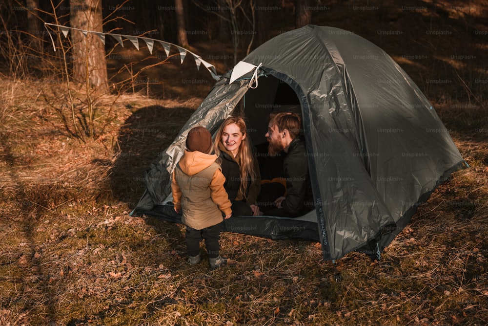 a couple of people standing inside of a tent