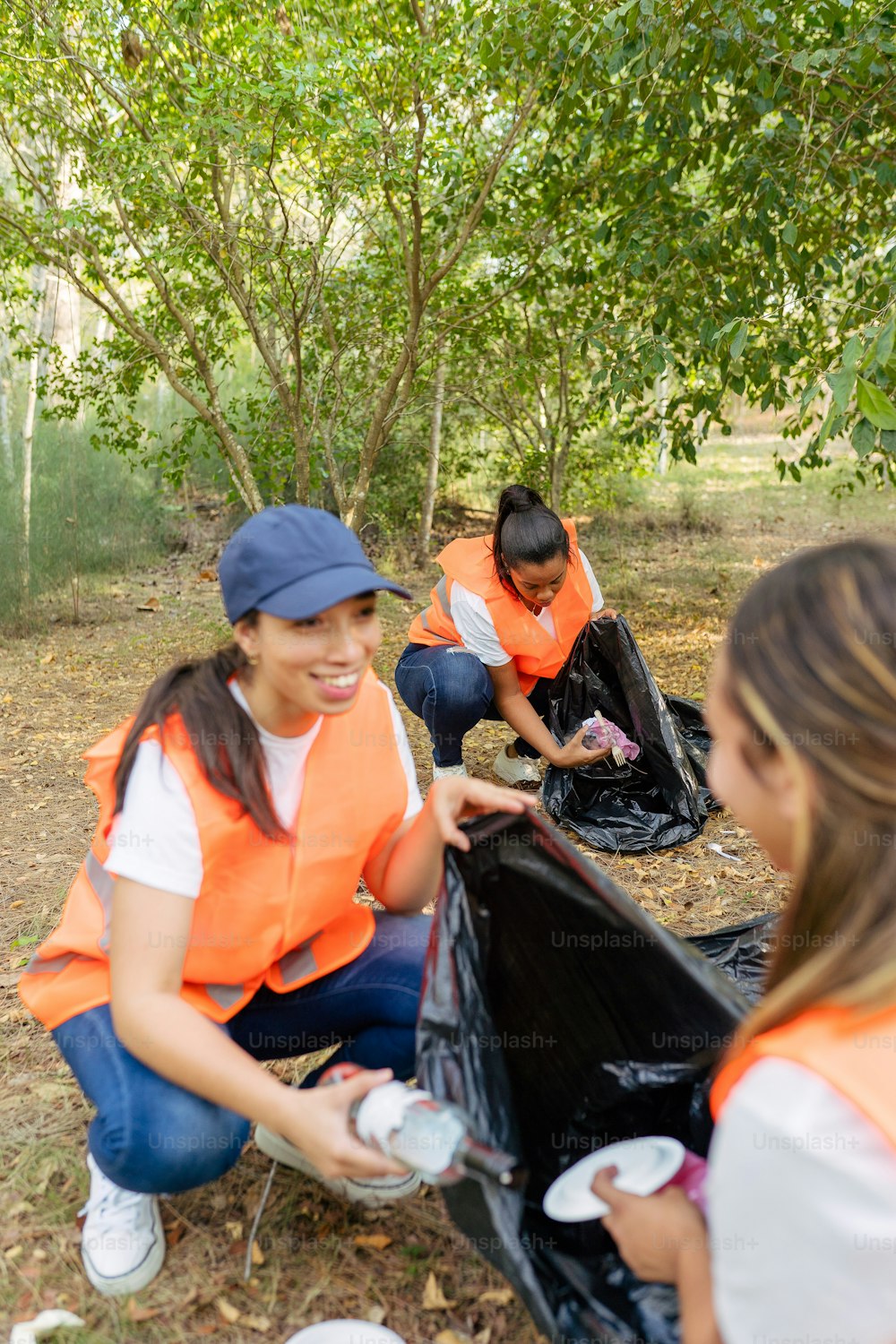 a group of people picking up trash in the woods