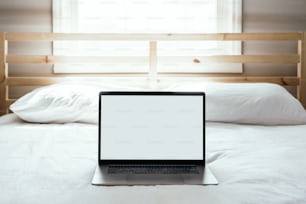 a laptop computer sitting on top of a bed