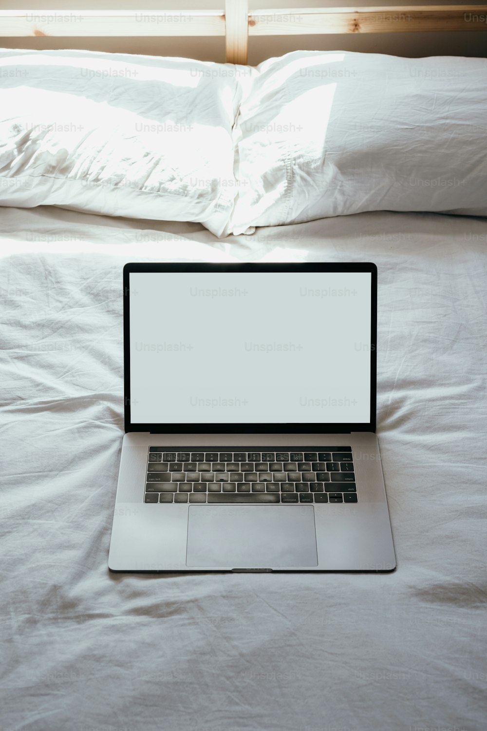 a laptop computer sitting on top of a bed