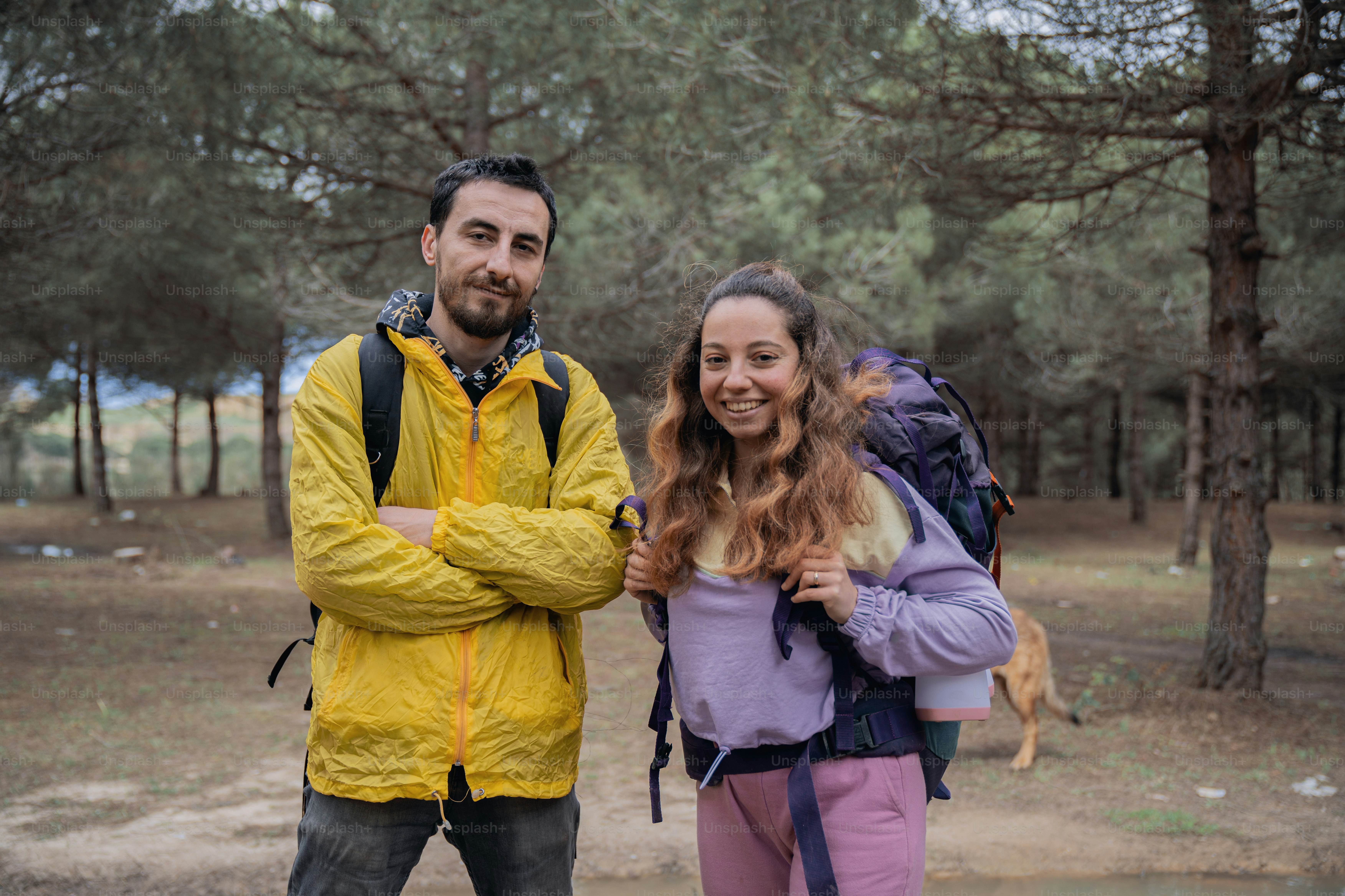 A man and a woman standing in the woods photo – Forest Image on Unsplash