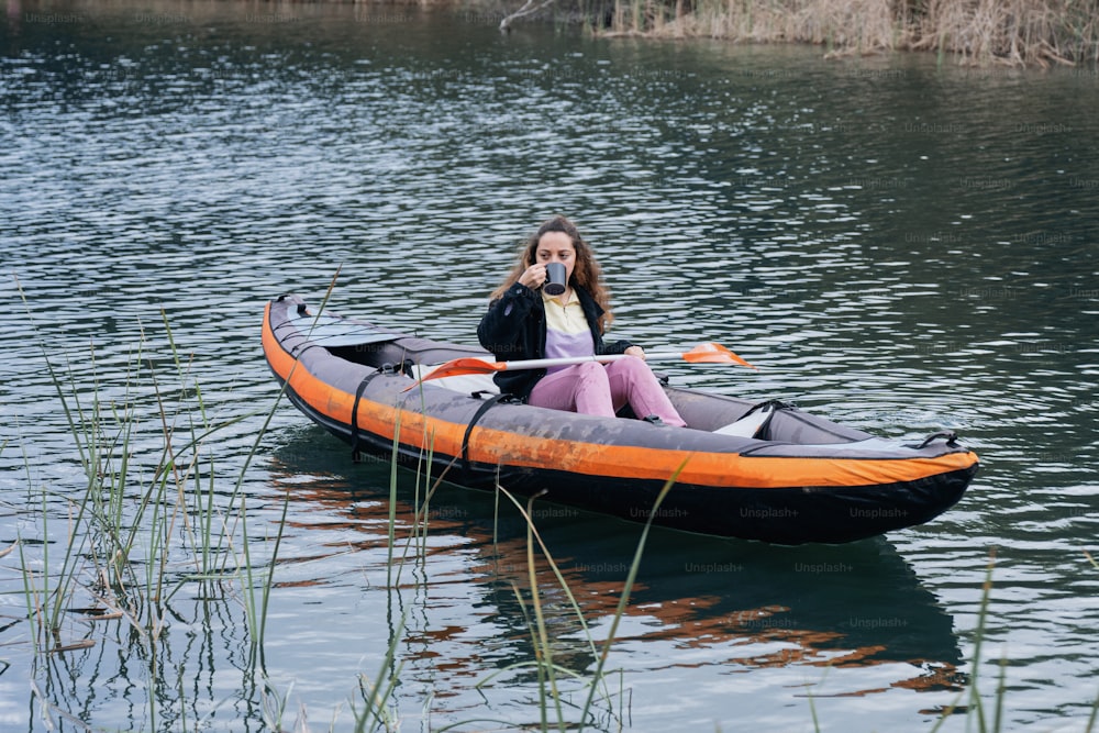 a girl is sitting in a boat on the water