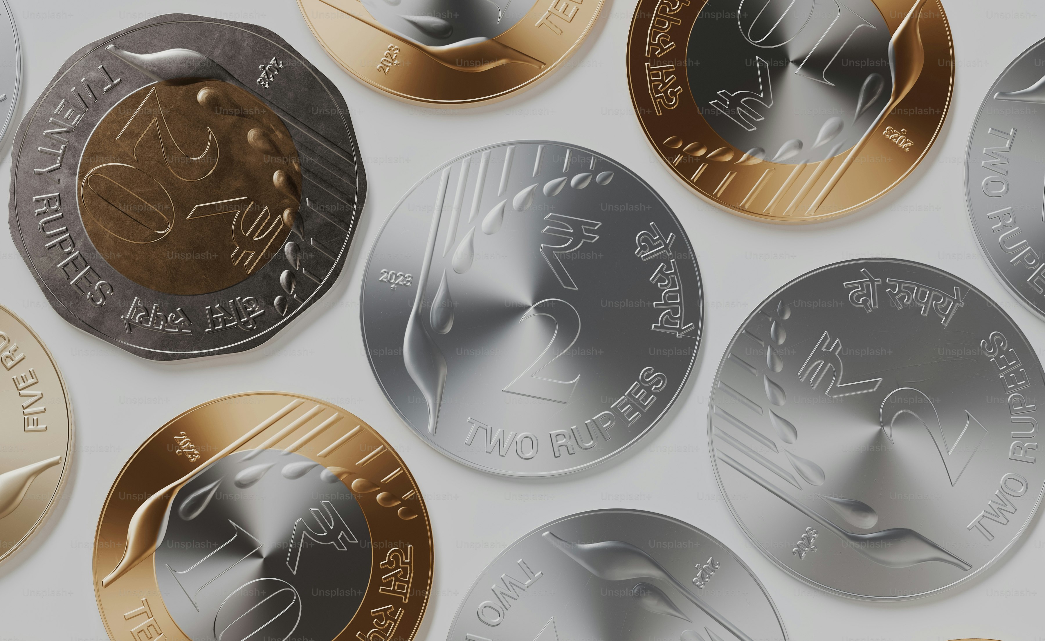 a bunch of different colored coins on a white surface