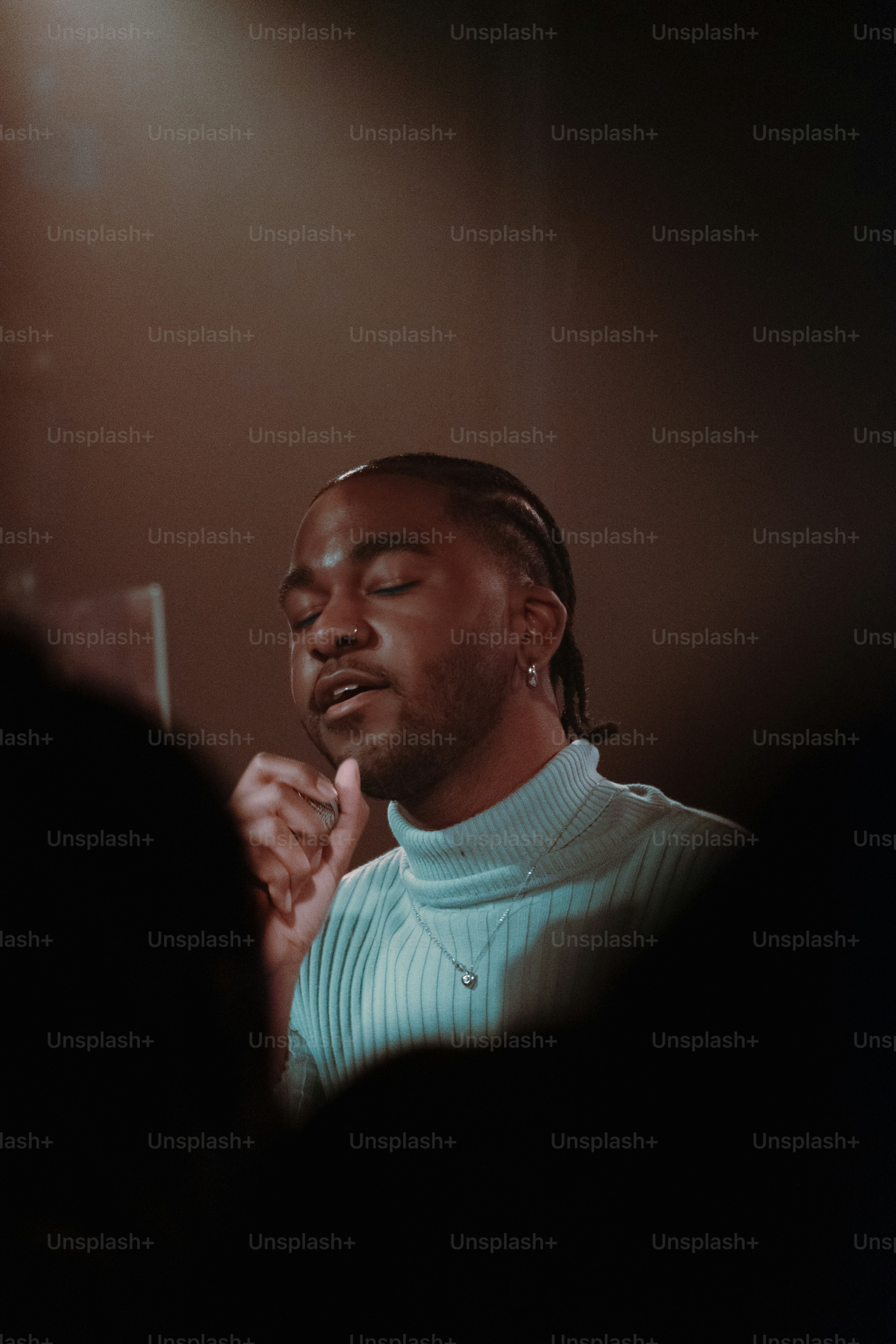 a man standing in front of a mirror with his eyes closed