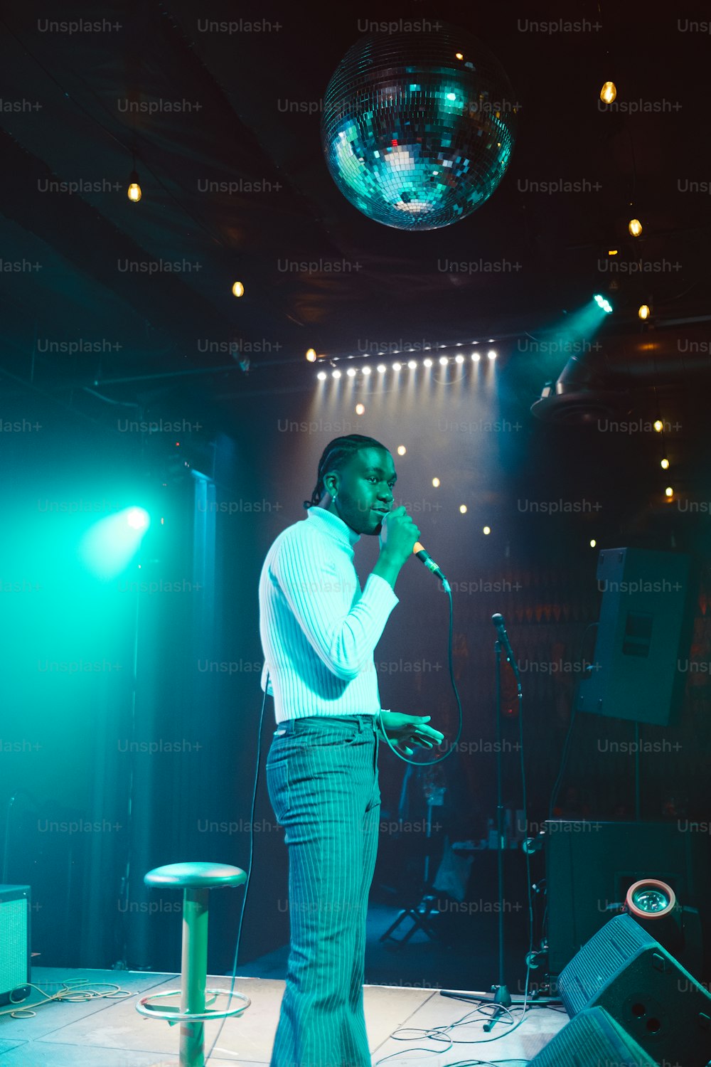 a man standing in front of a microphone on a stage