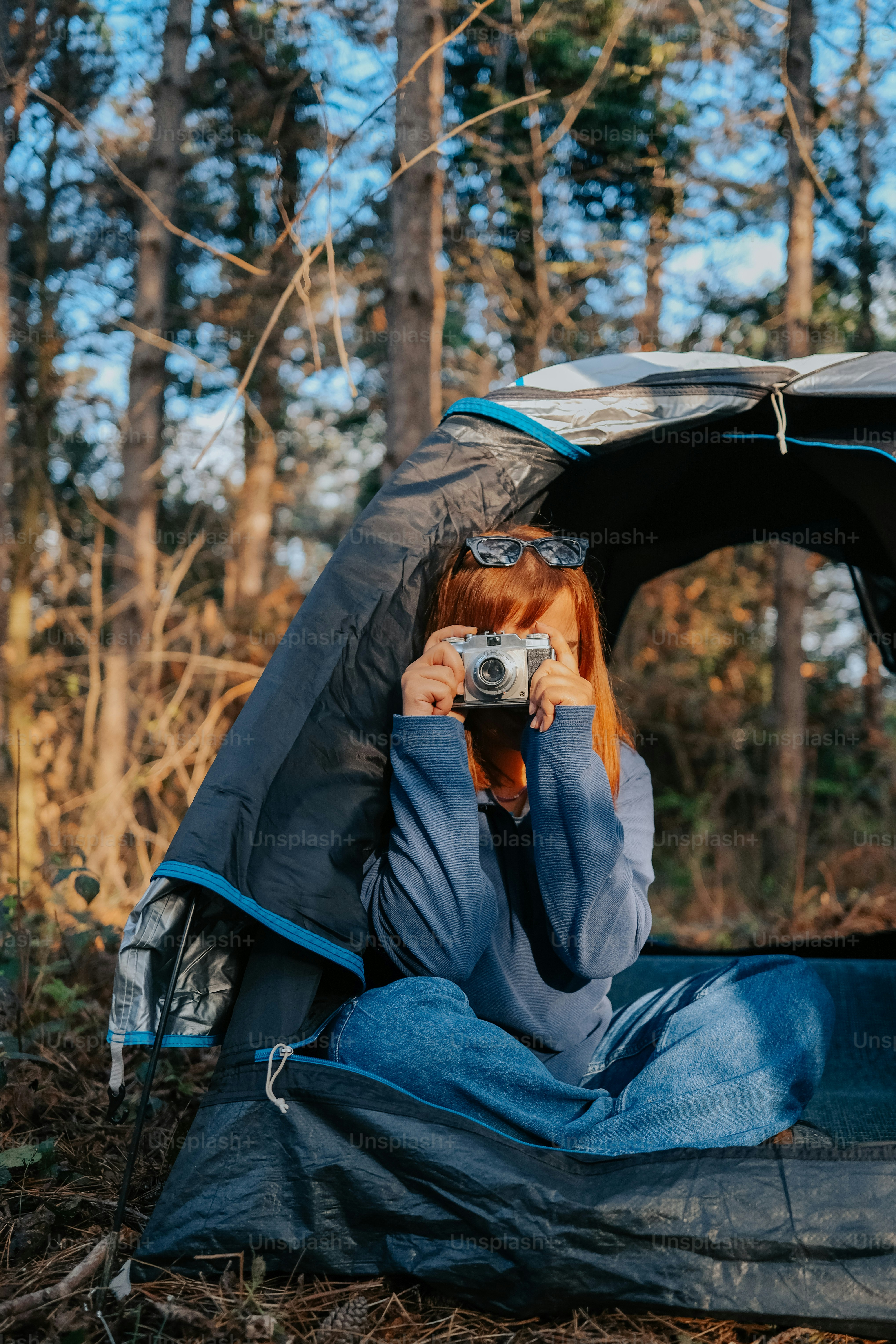 a woman taking a picture of herself in a tent
