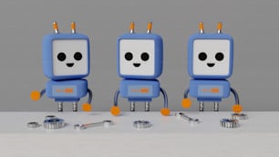 Un gruppo di tre piccoli robot seduti uno accanto all'altro