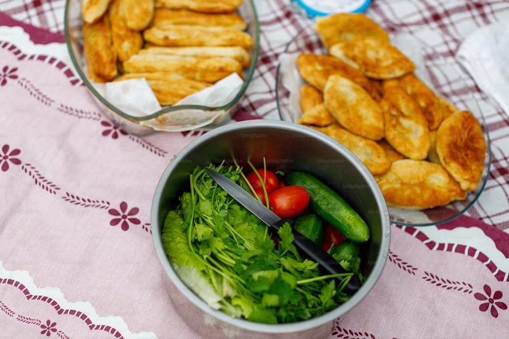 a bowl of salad and a bowl of bread on a table